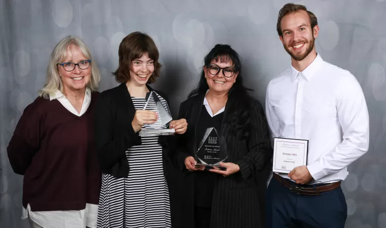 Amelia, Marcela and David pose with a member of the DDRC with their awards and nominations.