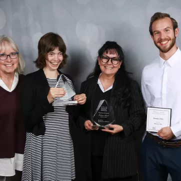 Amelia, Marcela and David pose with a member of the DDRC with their awards and nominations.